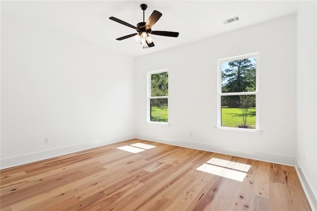 605 Northwoods Dr, Abita Springs, LA 70420 - empty room with healthy amount of natural light, wood finished floors, baseboards, and ceiling fan