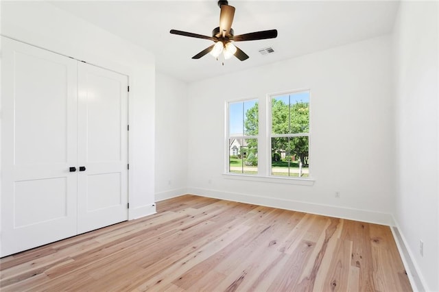 605 Northwoods Dr, Abita Springs, LA 70420 - unfurnished bedroom with a closet, light wood finished floors, baseboards, and a ceiling fan