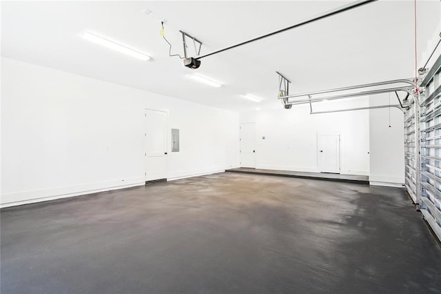 605 Northwoods Dr, Abita Springs, LA 70420 - garage featuring electric panel, a garage door opener, and baseboards