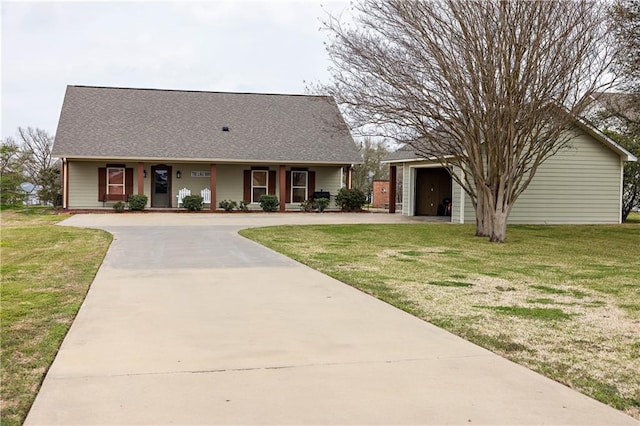 view of front facade featuring a garage, a front lawn, driveway, and a shingled roof