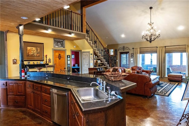 kitchen featuring stainless steel dishwasher, a sink, open floor plan, dark countertops, and concrete floors