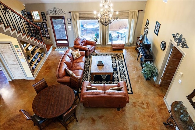 living room with stairs, a chandelier, baseboards, and a towering ceiling