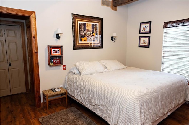 bedroom with wood finished floors and baseboards