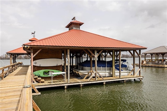 dock featuring boat lift and a water view