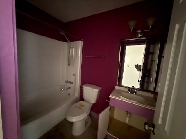 1535 Natchez Ln, La Place, LA 70068 - bathroom featuring toilet, washtub / shower combination, baseboards, and a sink