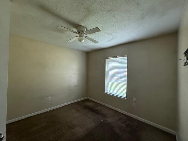 1535 Natchez Ln, La Place, LA 70068 - empty room with baseboards, ceiling fan, dark carpet, and a textured ceiling