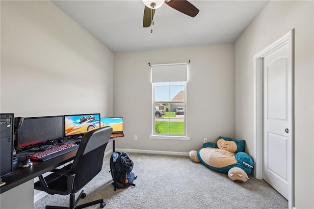 carpeted home office with a ceiling fan and baseboards