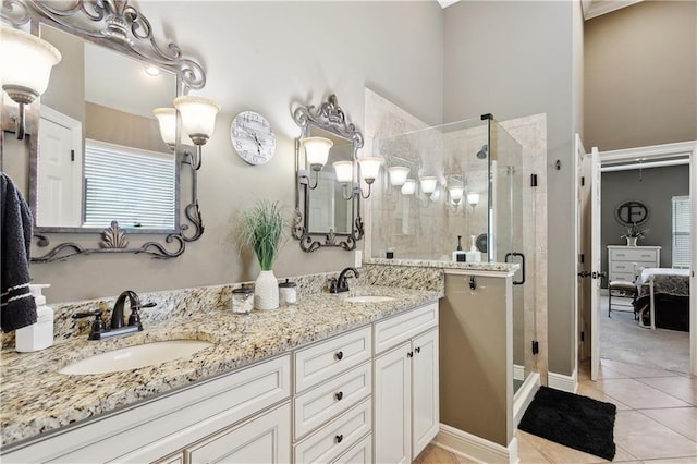 full bath with a shower stall, ensuite bath, tile patterned floors, and double vanity