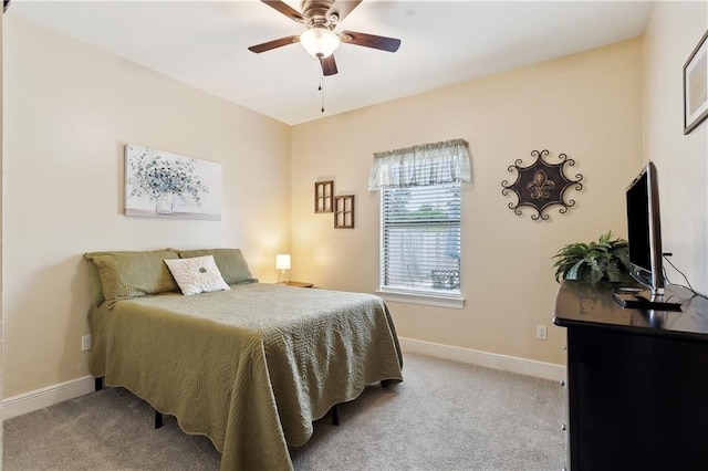 carpeted bedroom featuring baseboards and ceiling fan