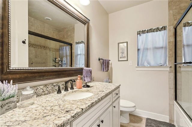 bathroom featuring vanity, toilet, and tile patterned flooring