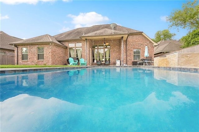 outdoor pool featuring fence