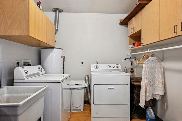 389 Hickory Dr, Slidell, LA 70458 - laundry area featuring water heater, washing machine and dryer, cabinet space, and light wood-type flooring