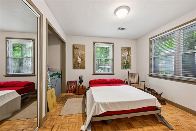 389 Hickory Dr, Slidell, LA 70458 - bedroom with a textured ceiling, a closet, and baseboards