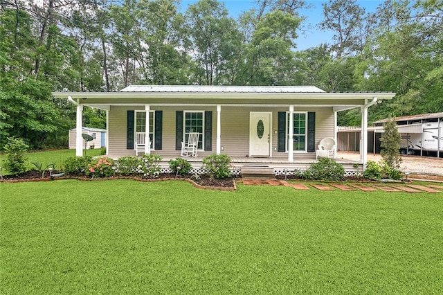 14356 Oak St, Tickfaw, LA 70466 - view of front of property with a front yard, a porch, and metal roof