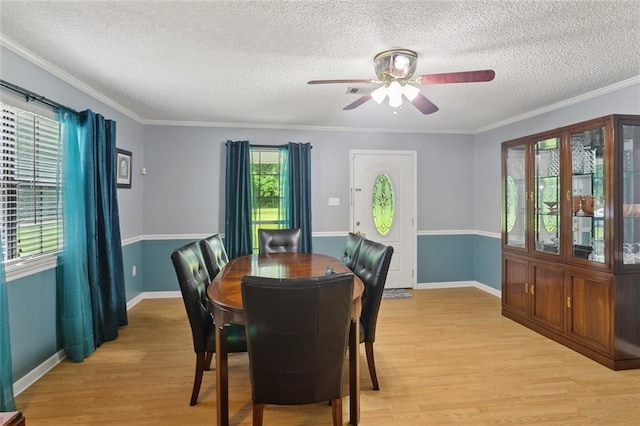 14356 Oak St, Tickfaw, LA 70466 - dining area with light wood-style flooring, plenty of natural light, a textured ceiling, a ceiling fan, and crown molding