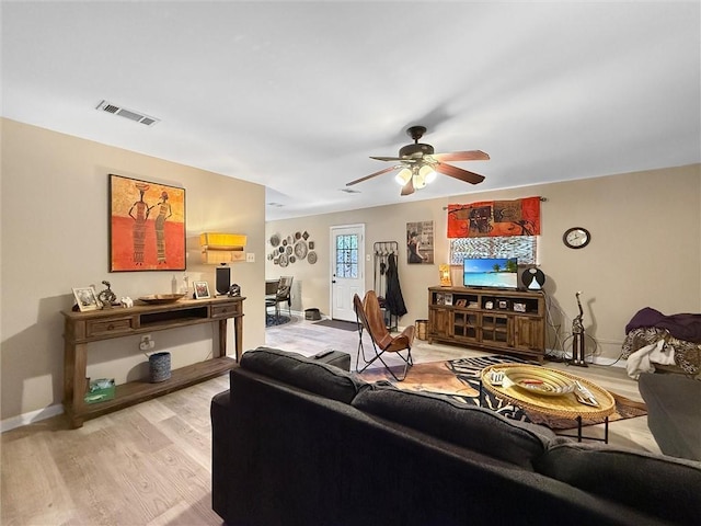 58207 Jefferson Ave, Slidell, LA 70460 - living area with light wood-type flooring, baseboards, and a ceiling fan