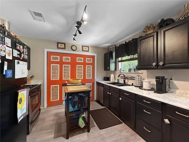 58207 Jefferson Ave, Slidell, LA 70460 - kitchen with stainless steel appliances, a sink, light countertops, and light wood finished floors