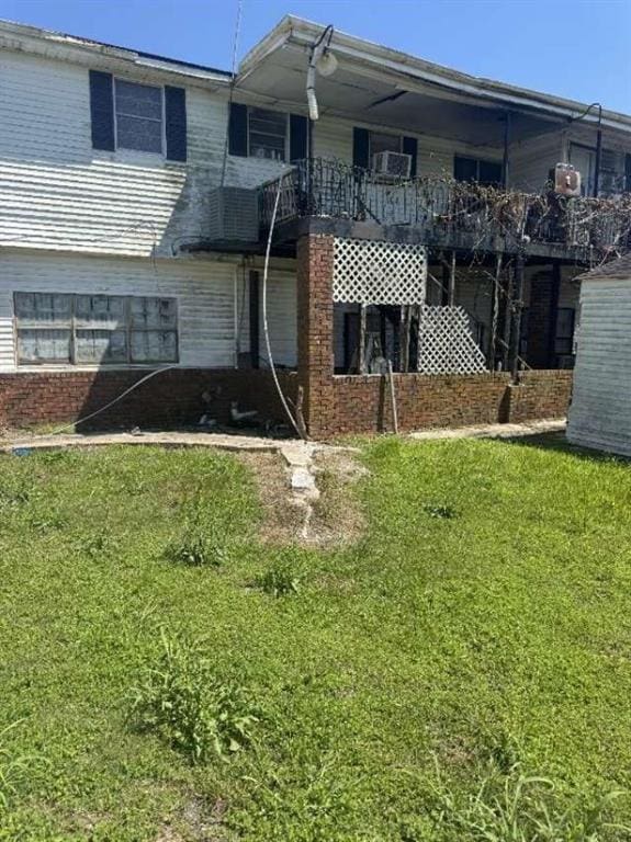 back of house with a lawn