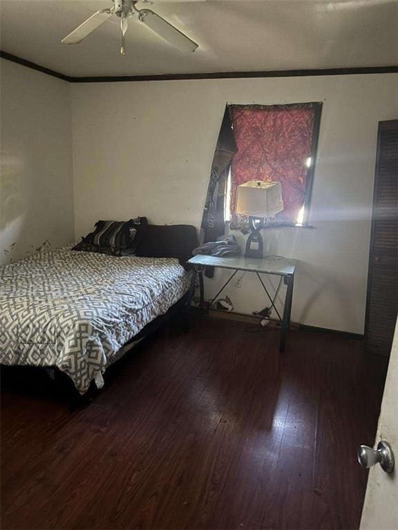 bedroom featuring ornamental molding, wood finished floors, and ceiling fan