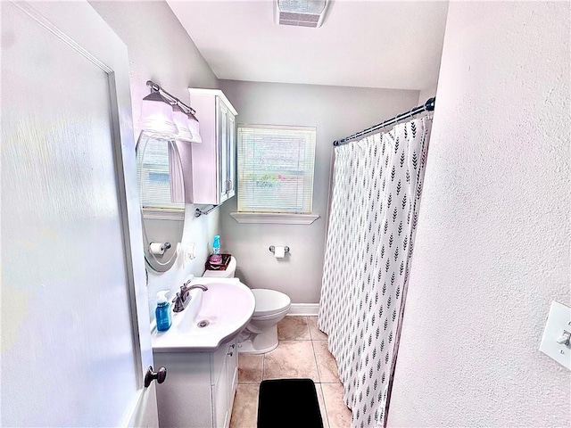 bathroom with toilet, tile patterned floors, vanity, and a shower with shower curtain