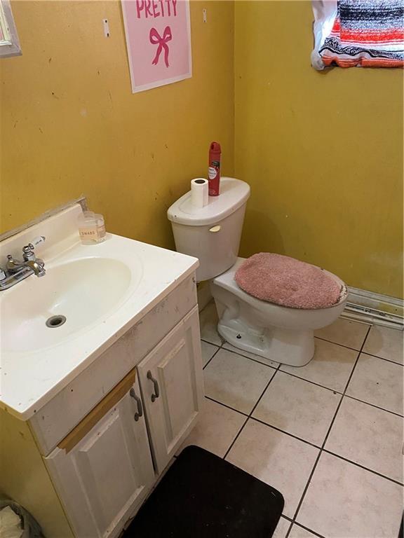 711012 Boston Dr, New Orleans, LA 70127 - half bathroom with vanity, toilet, and tile patterned flooring