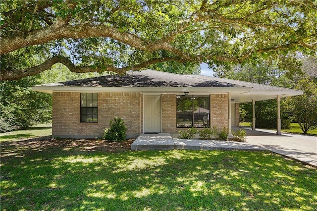 104 Maple Ridge Dr, Slidell, LA 70460 - view of front of house with brick siding, a front yard, concrete driveway, and a carport