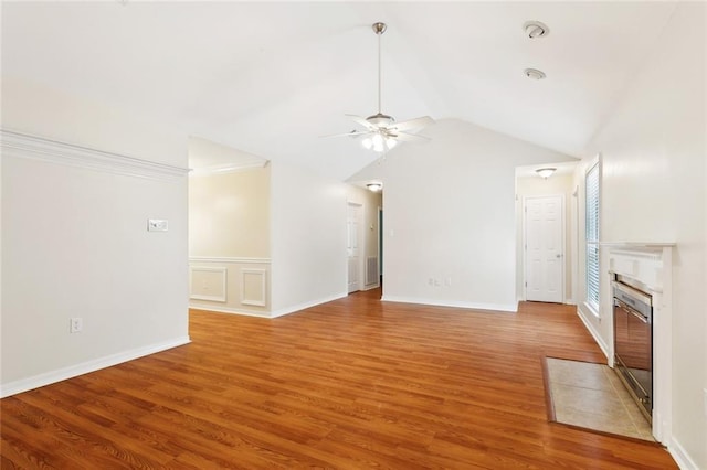 unfurnished living room with ceiling fan, light wood finished floors, a fireplace with flush hearth, and vaulted ceiling