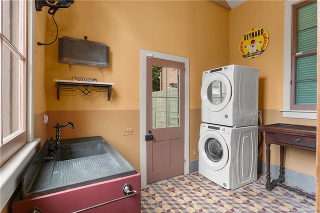 washroom featuring stacked washer / dryer and tile patterned floors