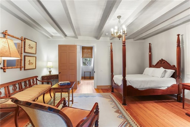 bedroom with beamed ceiling, light wood-style floors, a chandelier, and baseboards