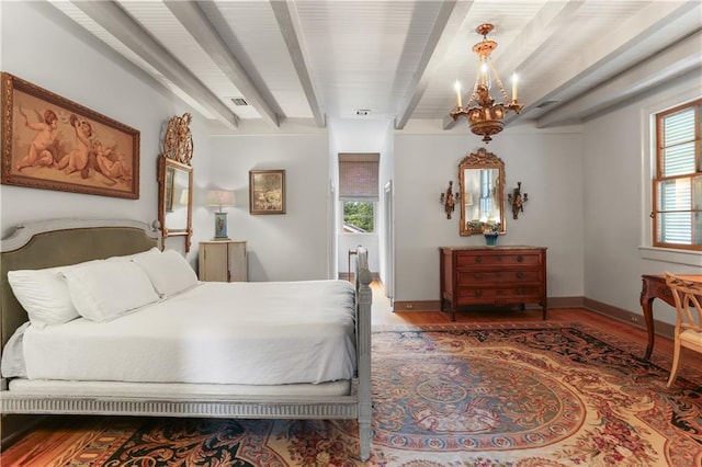 bedroom featuring a chandelier, beamed ceiling, wood finished floors, and baseboards