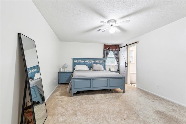 5037 Tartan Dr, Metairie, LA 70003 - bedroom with a textured ceiling, light carpet, a barn door, baseboards, and a ceiling fan