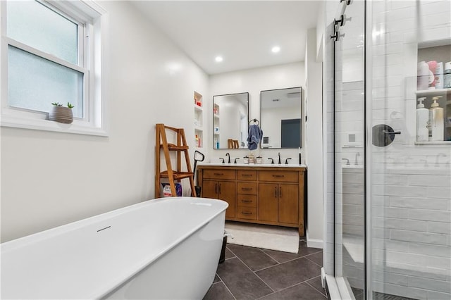 5037 Tartan Dr, Metairie, LA 70003 - bathroom with a shower stall, a freestanding tub, tile patterned floors, double vanity, and recessed lighting