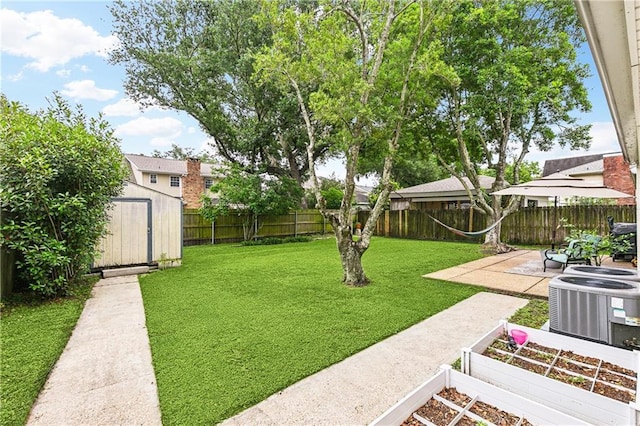 5037 Tartan Dr, Metairie, LA 70003 - view of yard with a vegetable garden, a patio area, a storage unit, cooling unit, and an outdoor structure