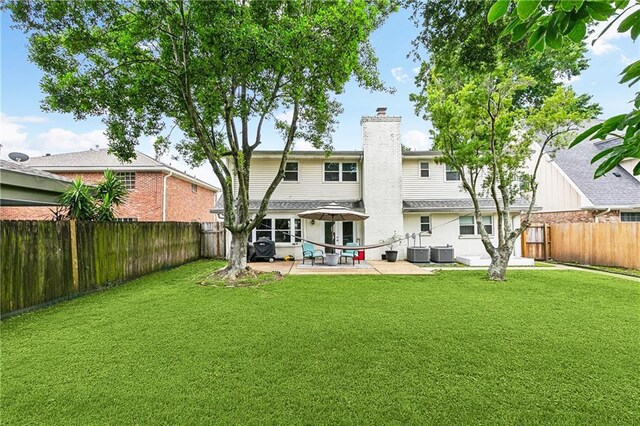 5037 Tartan Dr, Metairie, LA 70003 - rear view of property with central AC unit, a patio, and a chimney