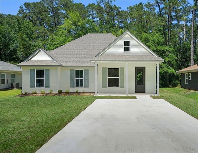 2441 Dupard St, Mandeville, LA 70448 - view of front of house featuring a shingled roof, a front yard, and a porch