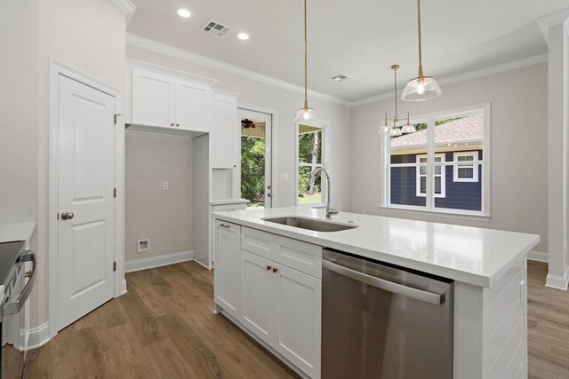 2441 Dupard St, Mandeville, LA 70448 - kitchen with dishwasher, a sink, wood finished floors, white cabinetry, and recessed lighting