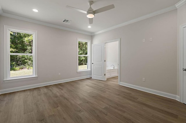 2441 Dupard St, Mandeville, LA 70448 - unfurnished bedroom featuring dark wood-style floors, baseboards, crown molding, recessed lighting, and connected bathroom