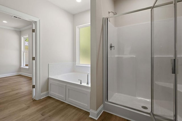 2441 Dupard St, Mandeville, LA 70448 - full bathroom with a shower stall, a garden tub, crown molding, wood finished floors, and baseboards