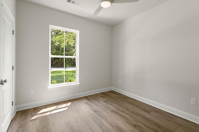 2441 Dupard St, Mandeville, LA 70448 - empty room featuring healthy amount of natural light, wood finished floors, a ceiling fan, and baseboards