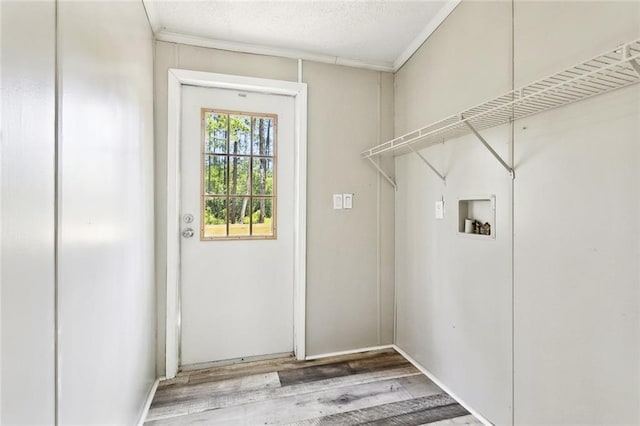 25259 Bunker St, Abita Springs, LA 70420 - clothes washing area with washer hookup, ornamental molding, and wood finished floors