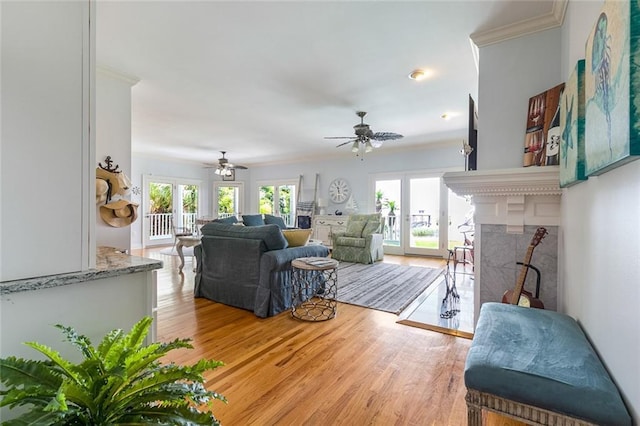 228 Marlin Dr, Slidell, LA 70461 - living room featuring healthy amount of natural light, ceiling fan, wood finished floors, crown molding, and a fireplace
