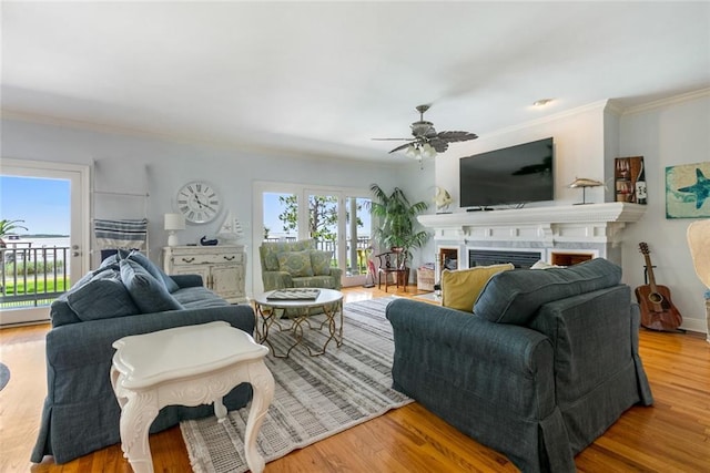 228 Marlin Dr, Slidell, LA 70461 - living room featuring a fireplace, ornamental molding, a ceiling fan, and wood finished floors