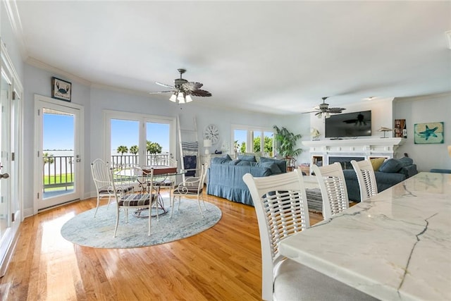 228 Marlin Dr, Slidell, LA 70461 - dining room featuring ceiling fan, crown molding, light wood finished floors, and a fireplace