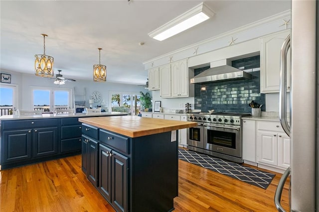 228 Marlin Dr, Slidell, LA 70461 - kitchen with stainless steel appliances, wood counters, a center island, and white cabinets
