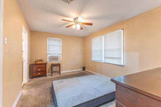 bedroom with light colored carpet, multiple windows, baseboards, and ceiling fan