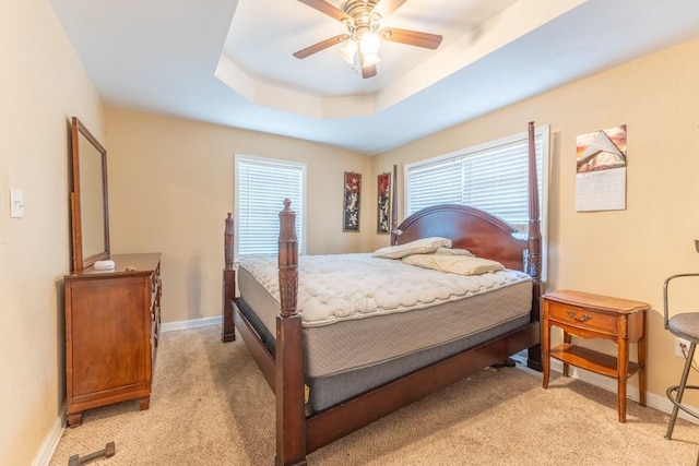 4624 Wright Rd, New Orleans, LA 70128 - bedroom featuring light colored carpet, baseboards, a tray ceiling, and ceiling fan