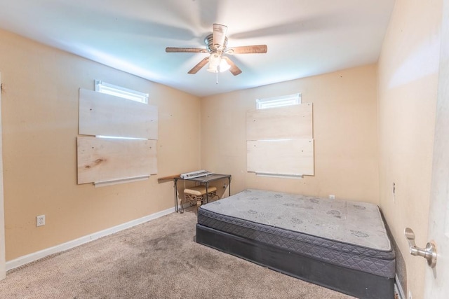 bedroom with multiple windows, carpet flooring, baseboards, and ceiling fan