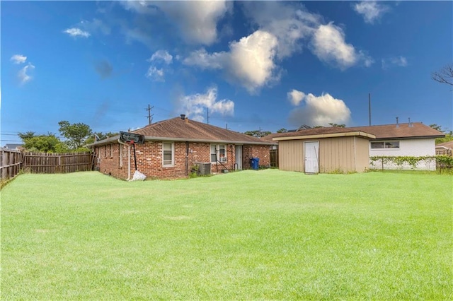 rear view of property featuring an outdoor structure, a storage unit, brick siding, and cooling unit