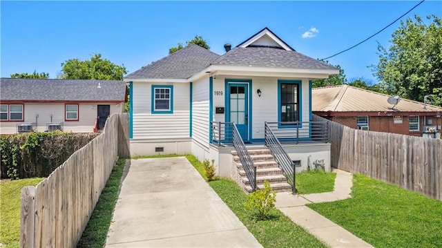 1919 N Prieur St, New Orleans, LA 70116 - bungalow-style house with covered porch, a shingled roof, fence, central AC, and crawl space