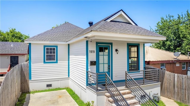 1919 N Prieur St, New Orleans, LA 70116 - view of front facade featuring crawl space, fence, and roof with shingles